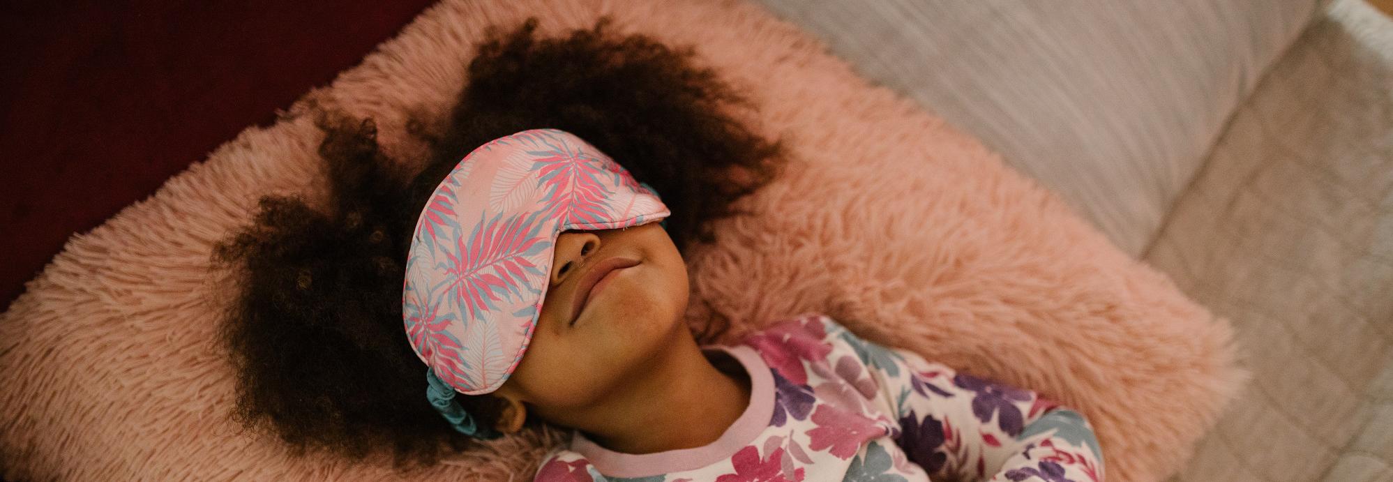 child sleeping with eye mask